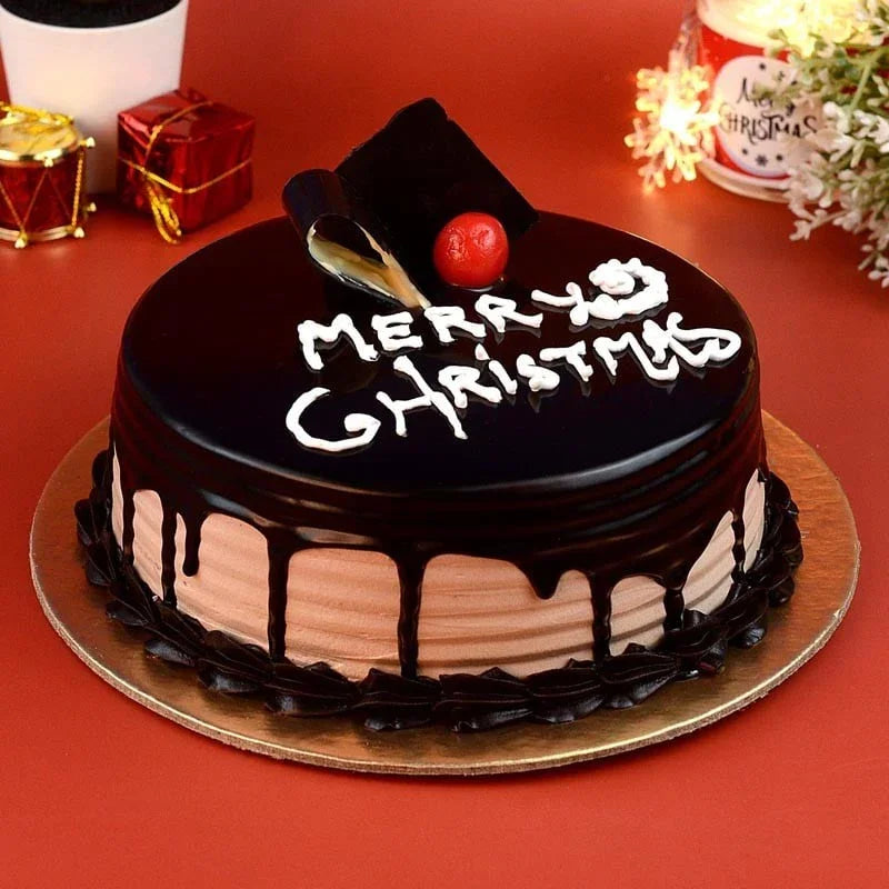 Chocolate cake with 'Merry Christmas' decoration on a red background