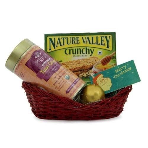 Christmas gift basket with Nature Valley granola bars, organic Tulsi green tea, ornament, and card