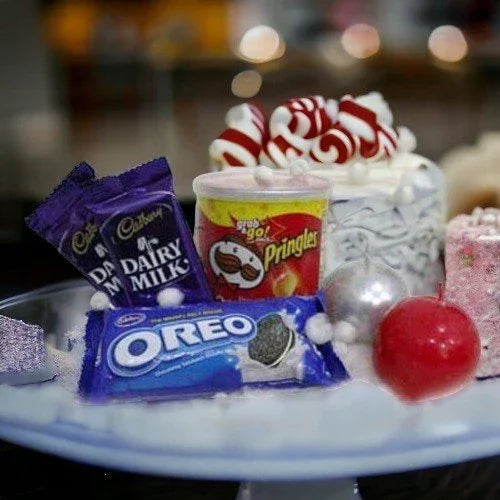 Gift platter with Dairy Milk chocolate, Oreo cookies, Pringles, cake, and candies