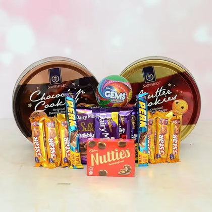 Assorted candy and chocolate bars in a display with branded tins.