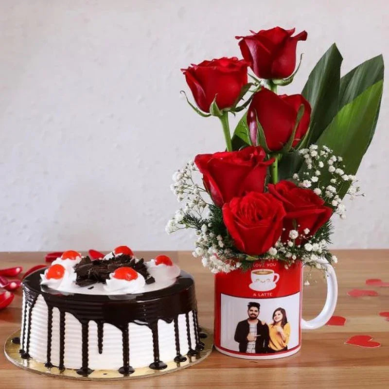 Chocolate cake with red roses in a mug on a wooden table
