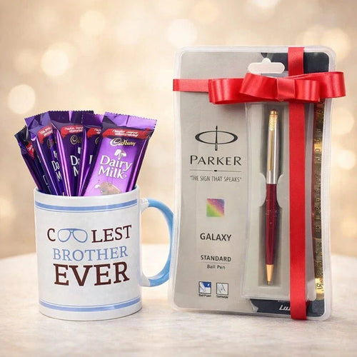 Mug with Cadbury Dairy Milk chocolate bars and a Parker pen set on a blurred background