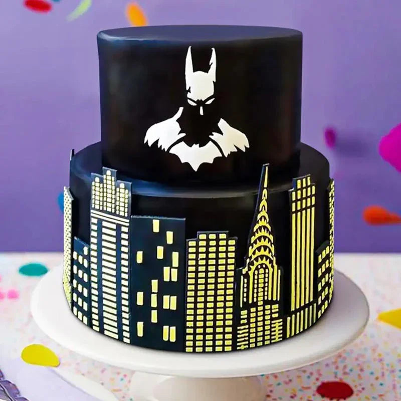Two-tiered cake with Batman silhouette and city skyline design on a colorful background