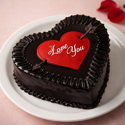 Heart-shaped chocolate cake with a red heart and 'Love You' text on a pink background