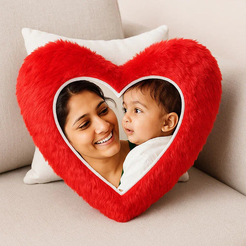 Red heart-shaped fur cushion with a printed photo of a smiling mother and baby.