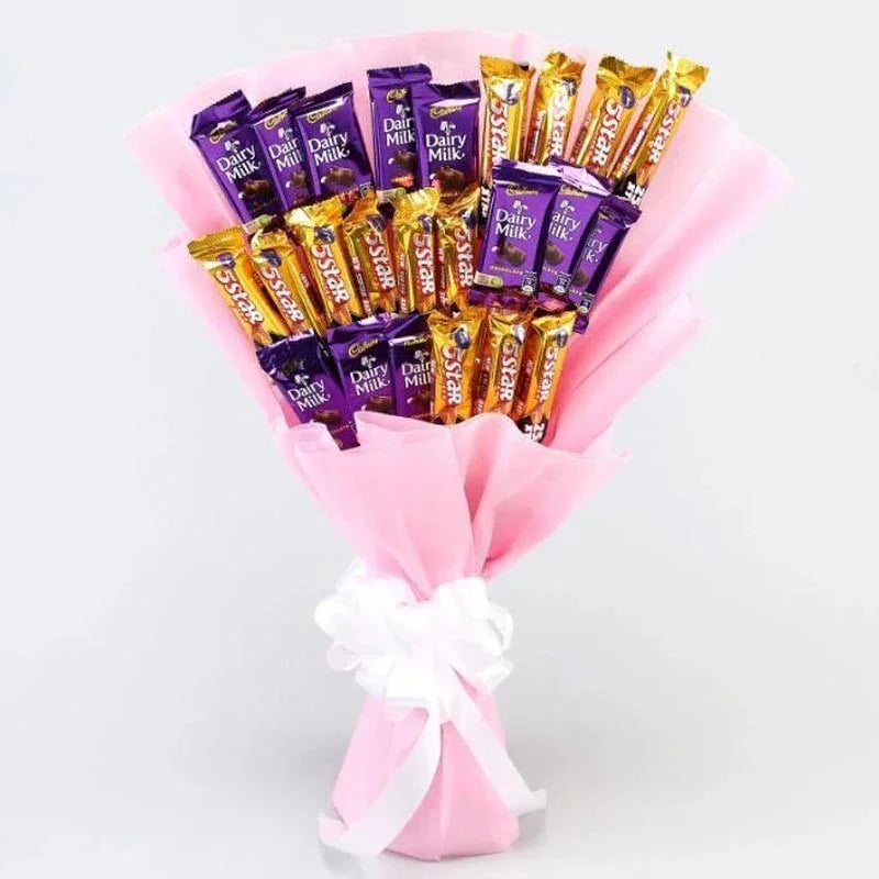 Bouquet of Cadbury chocolate bars wrapped in pink paper with a white bow on a light gray background