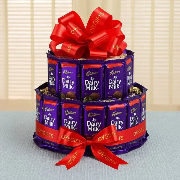 Tiered Dairy Milk chocolate bar bouquet with red ribbon, perfect for gifting occasions.