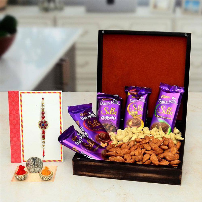 Dessert platter with Cadbury Dairy Milk Silk chocolate bars and dry fruits on a kitchen counter.
