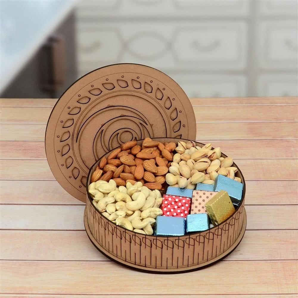 Wooden bowl with dry fruits and colorful boxes on a wooden surface