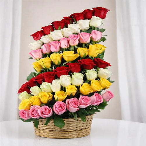Basket arrangement with red, yellow, pink, and white roses for gifting occasions