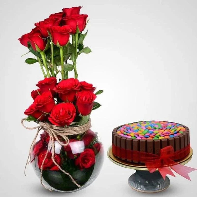 Bouquet of red roses and a colorful chocolate cake on a white background