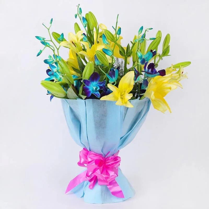 Bouquet of flowers wrapped in blue paper with a pink ribbon on a white background