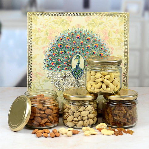 Jars of nuts and seeds with a decorative card featuring a peacock design on a white surface.