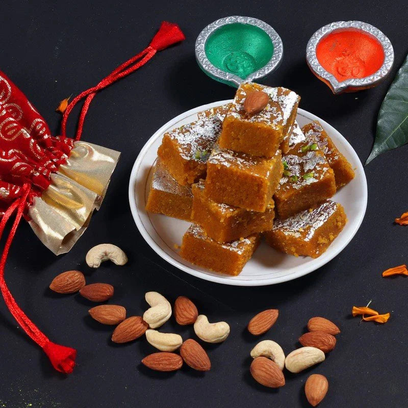 Plate of brown square sweets with nuts on a dark 2 Diya