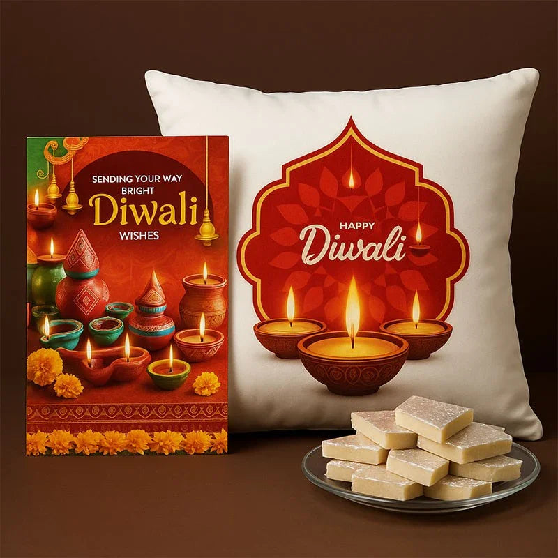 Diwali-themed pillow, card, and plate of sweets on a brown background