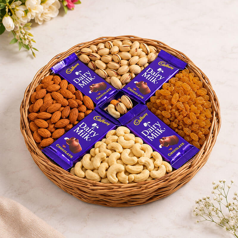 Basket of Cadbury Dairy Milk chocolate bars with nuts and dried fruits on a light background