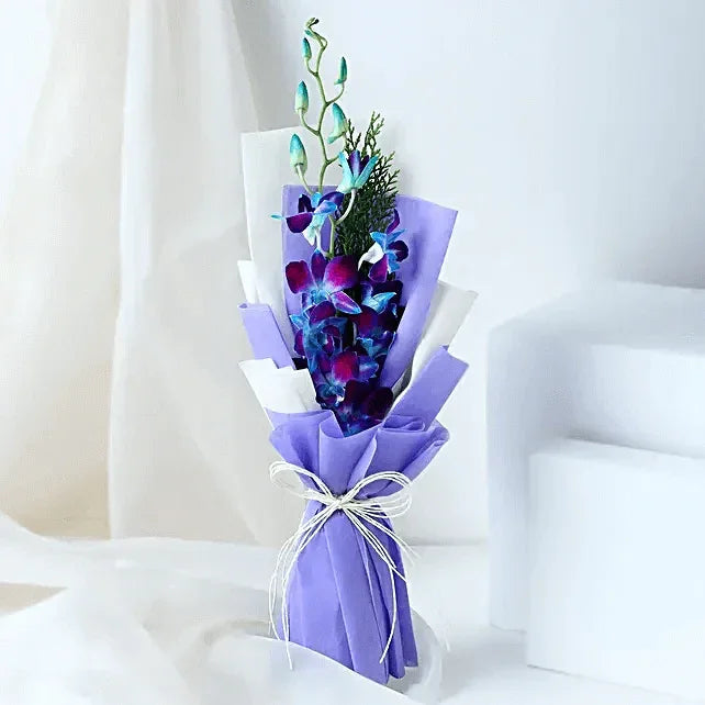 Elegant blue orchid bouquet wrapped in purple and white paper, tied with a string bow