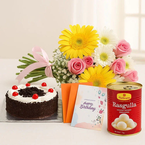 Birthday cake, flowers, card, and Rasgulla on a table