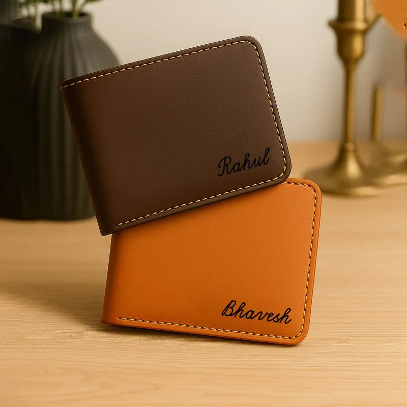 Two leather wallets, one brown and one orange, on a wooden surface.