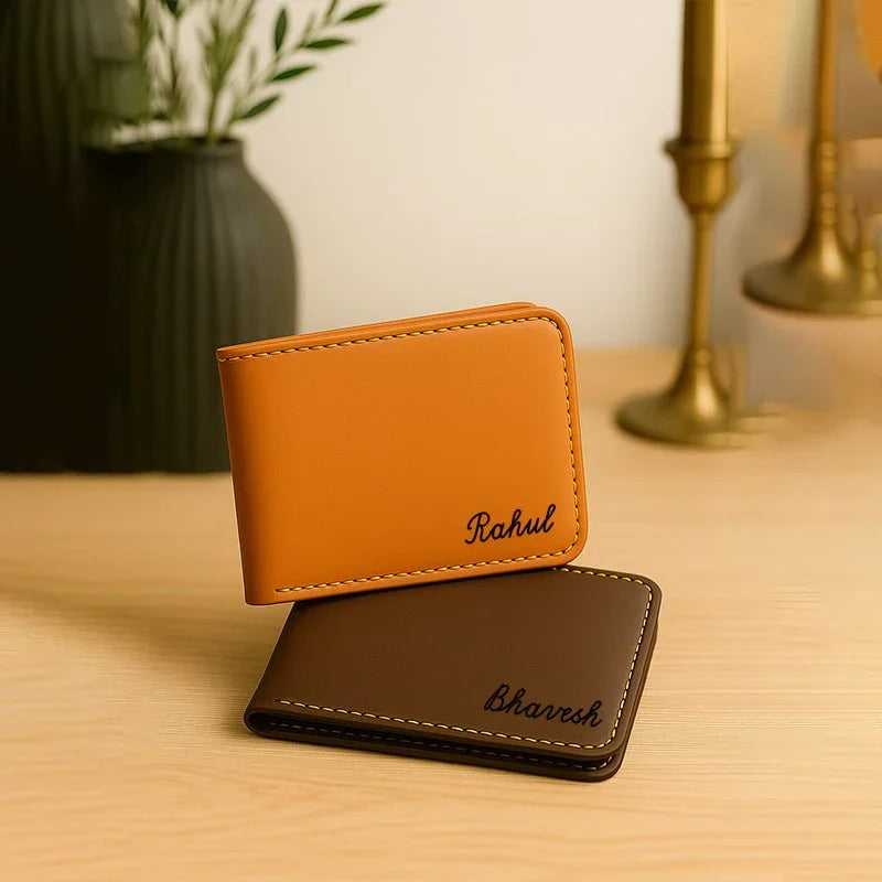 Two leather wallets, one orange and one brown, on a wooden surface with a blurred background.