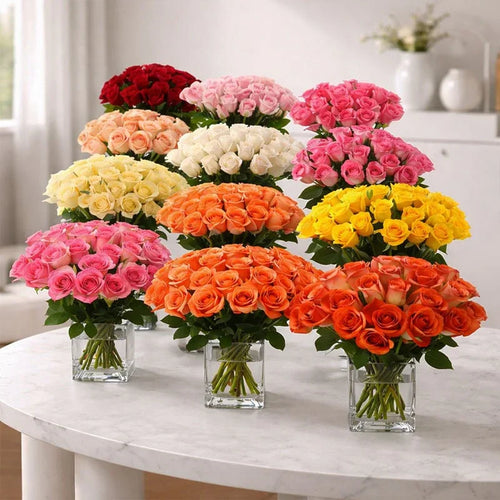 Mixed color rose bouquets in glass vases on a white table, perfect for gifting occasions