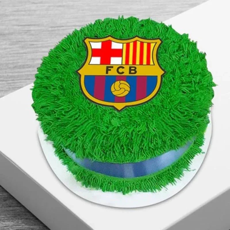 Green cake with FC Barcelona logo on a white surface