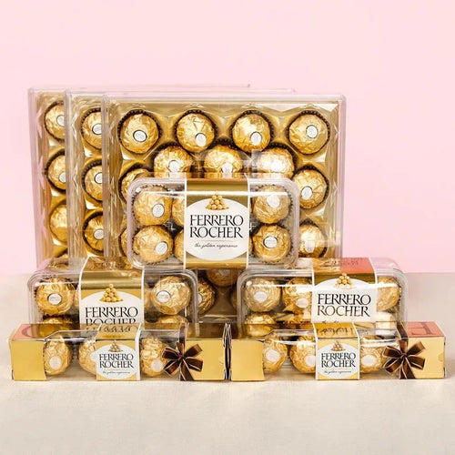 Ferrero Rocher chocolate boxes of different sizes on a light pink background