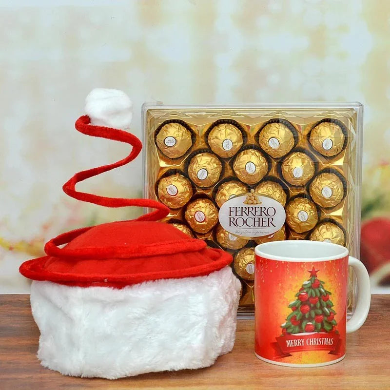 Ferrero Rocher chocolate set with a Santa hat and Christmas-themed mug on a wooden surface.