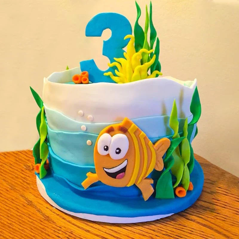 Children's birthday cake with ocean theme, fish decoration, and number 3
