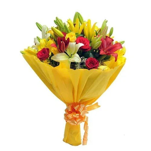 Mixed flower bouquet with yellow lilies, white lilies, red roses and yellow wrap