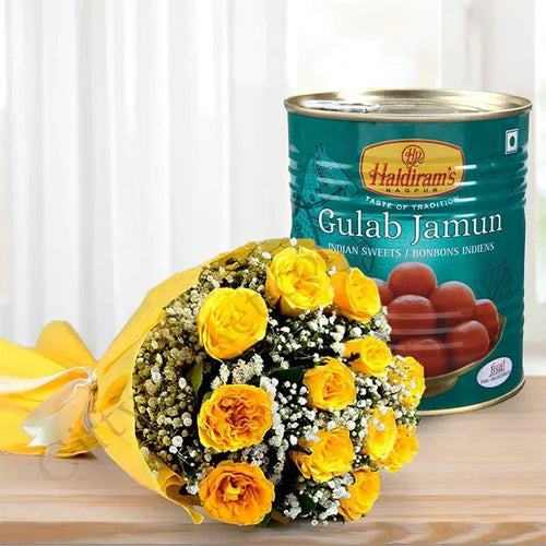 Bouquet of yellow flowers next to a can of Haldiram's Gulab Jamun on a wooden surface.