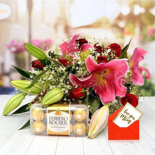 Bouquet of flowers with Ferrero Rocher chocolates and a card saying 'I love you Mom' on a blurred background.