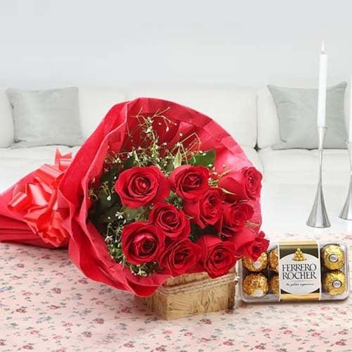 Red rose bouquet and Ferrero Rocher chocolates on a floral tablecloth in a cozy living room