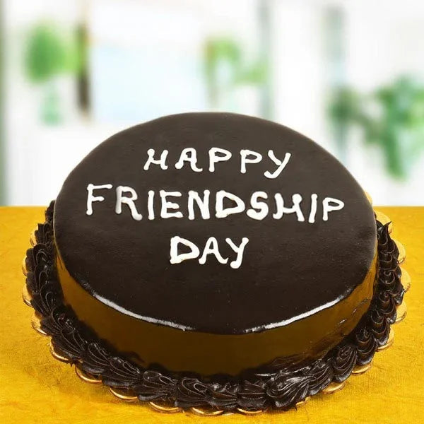 Chocolate cake with 'Happy Friendship Day' text on a yellow surface