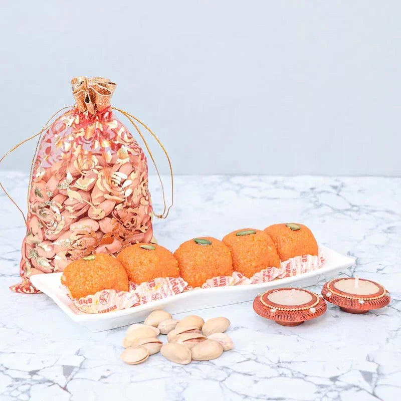 Decorative bag with pumpkins and candles on a marble surface