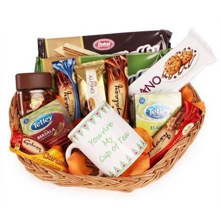 Gift basket with snacks, coffee, and a mug on a white background