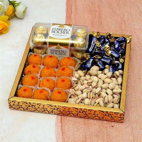 Assorted Motichoor laddu and nuts in a candies, Ferrero Rocher chocolate box on a light background