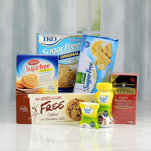 Assorted sugar-free products including cookies, tea, and candy on a white surface with a light gray curtain background.