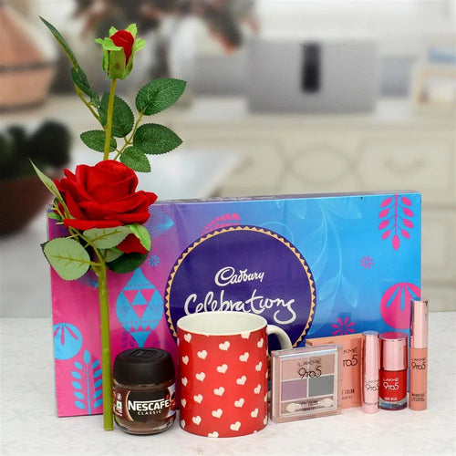 Gift set with Cadbury chocolate, Nescafe, makeup, and a rose on a blurred background