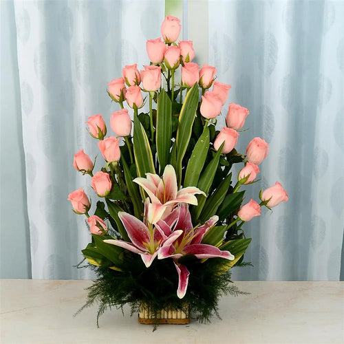 Bouquet of pink roses and lilies on a light surface with a light curtain 