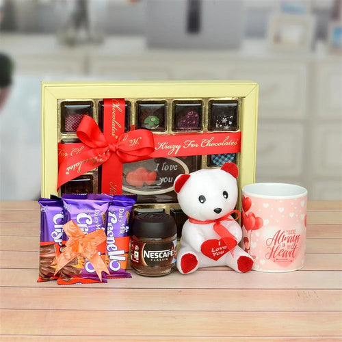 Gourmet chocolate set with a teddy bear, coffee, and a mug