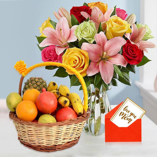 Fruit basket with flowers and a card on a light background