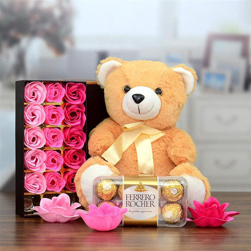 Teddy bear with Ferrero Rocher chocolates and pink flowers 