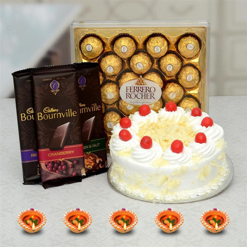 Ferrero Rocher chocolate box, Bournville chocolate bars, and a cake on a gray surface.