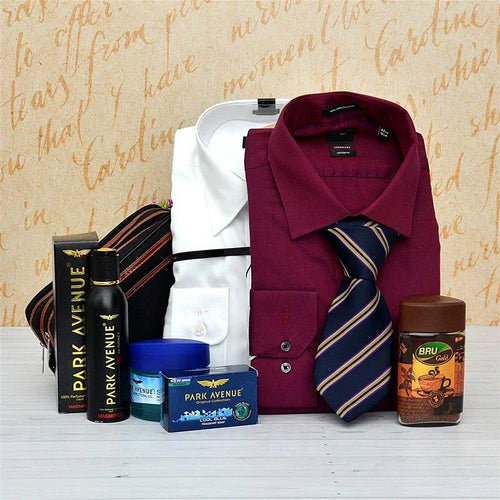 Collection of men's formal wear and accessories on a wooden surface with a decorative background.