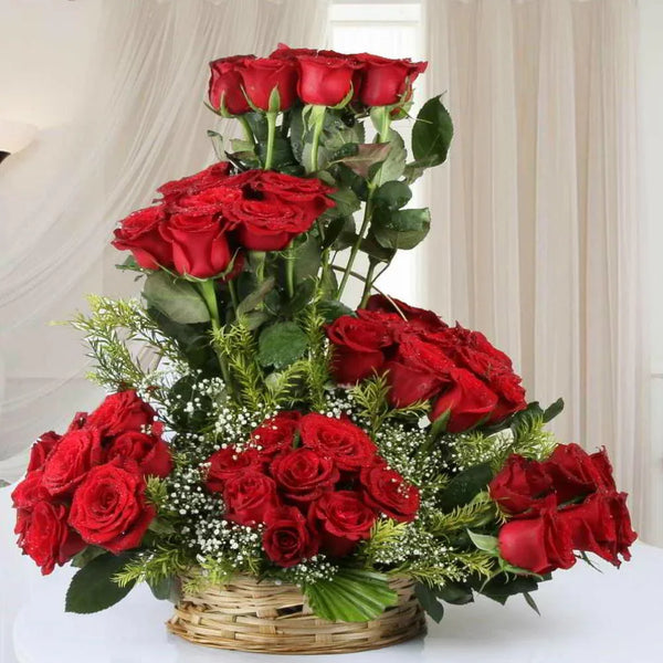 Bouquet of red roses in a woven basket on a white background
