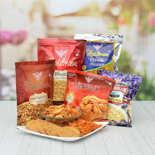 Assorted Haldiram snacks and packaging on a white surface 