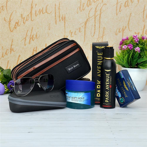 Grooming products including a pouch, sunglasses, and hair care items Perfume on a decorative background.