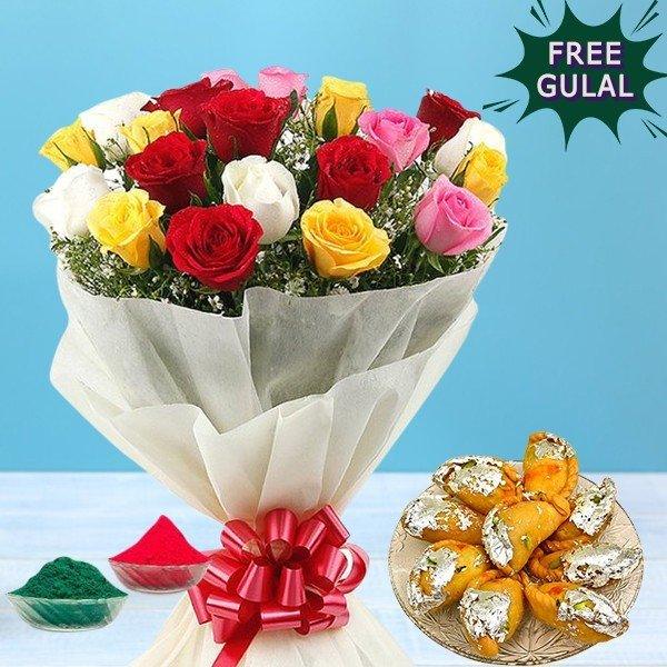 Bouquet of multicolored roses with a red bow, free gulal, and sweet items on a blue background