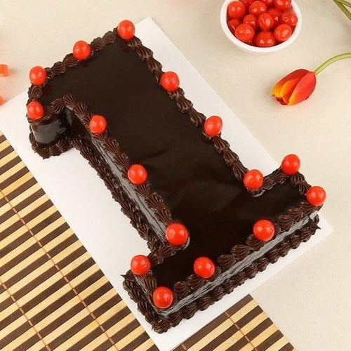 Chocolate cake with red berries on a white plate, surrounded by red berries and tulips.